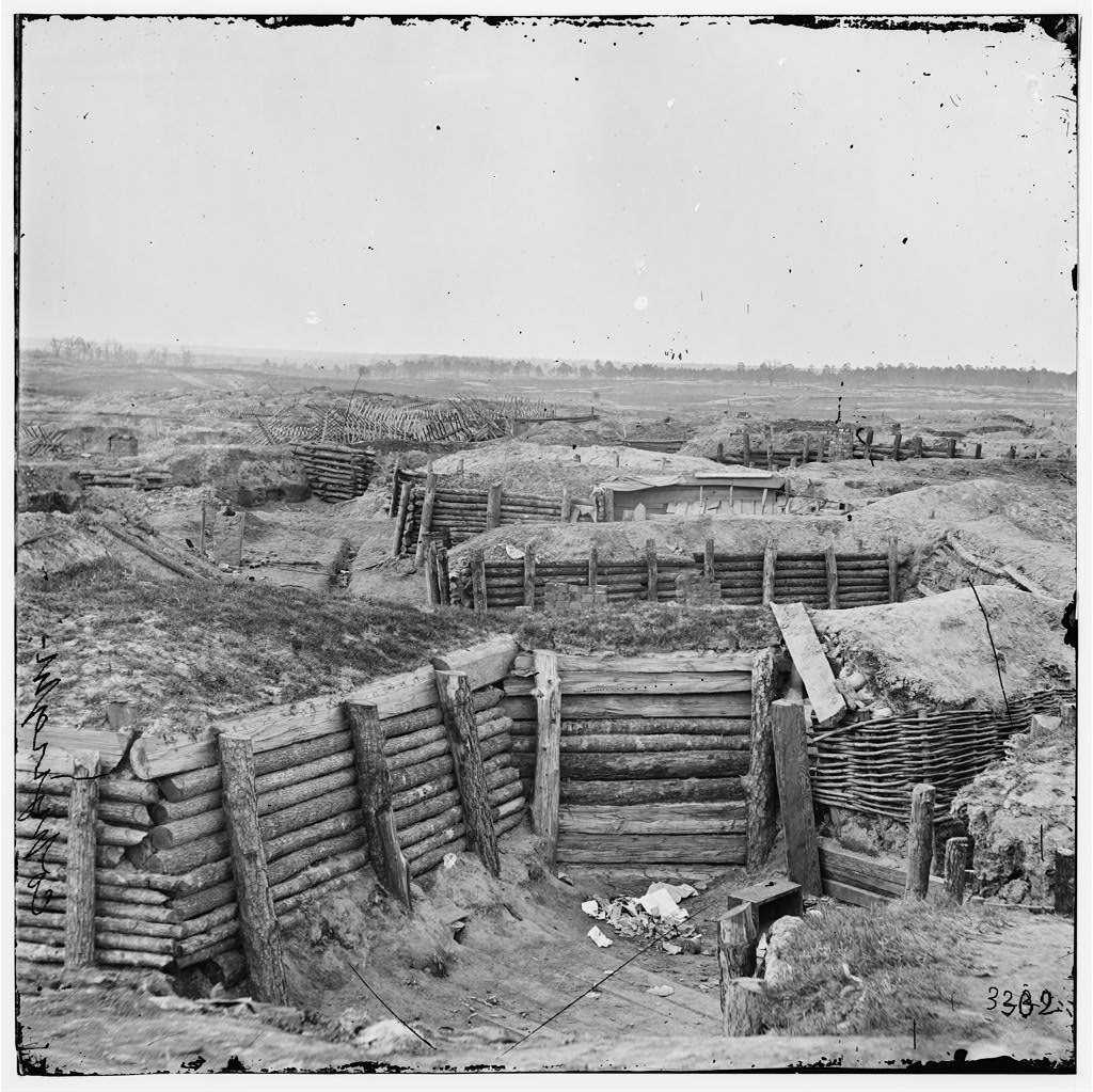Civil War photograph of Confederate earthwork fortifications at Petersburg, Virginia, with chevaux-de-frise obstacles beyond.